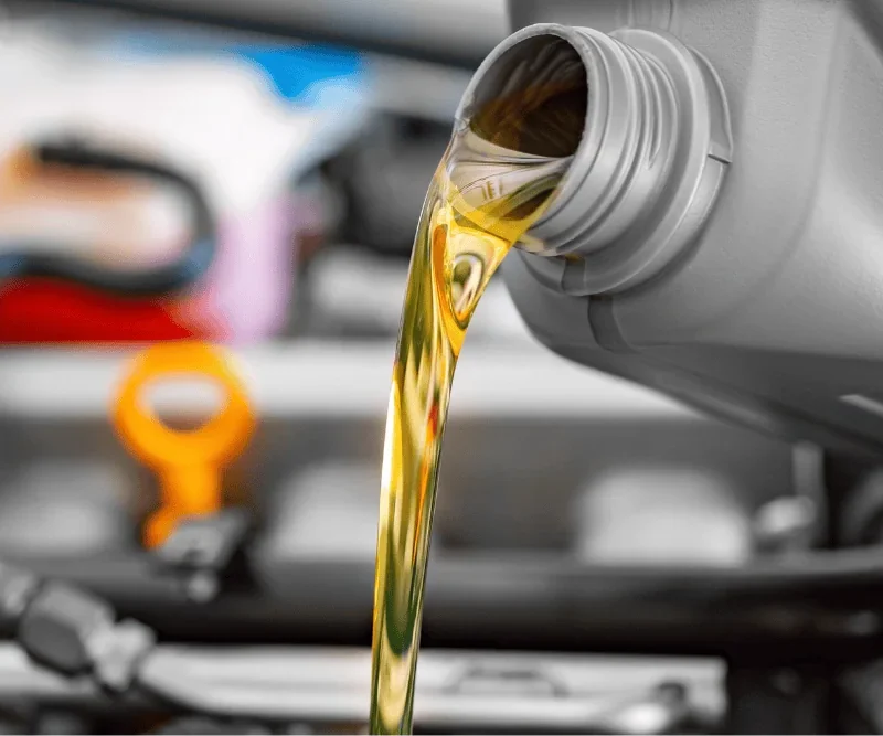 Technician checking engine oil level during an oil change at RPM Auto Center in Irwindale