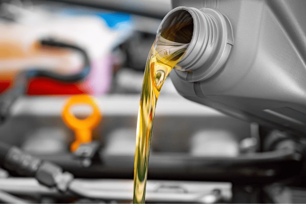 Technician checking engine oil level during an oil change at RPM Auto Center in Irwindale